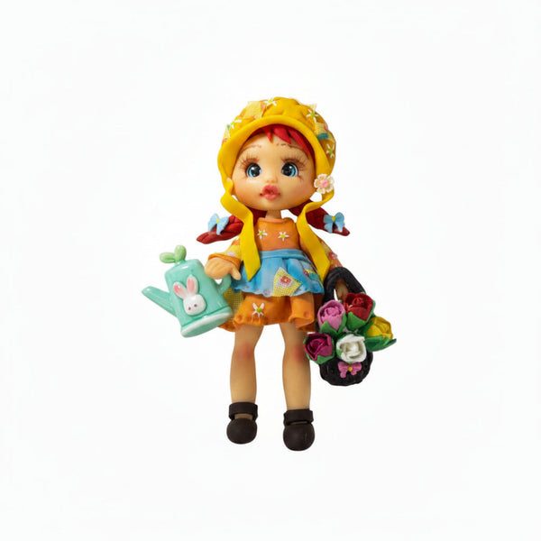 Handmade flexible porcelain garden girl doll charm with red hair, a yellow hat, green watering can, and rose basket