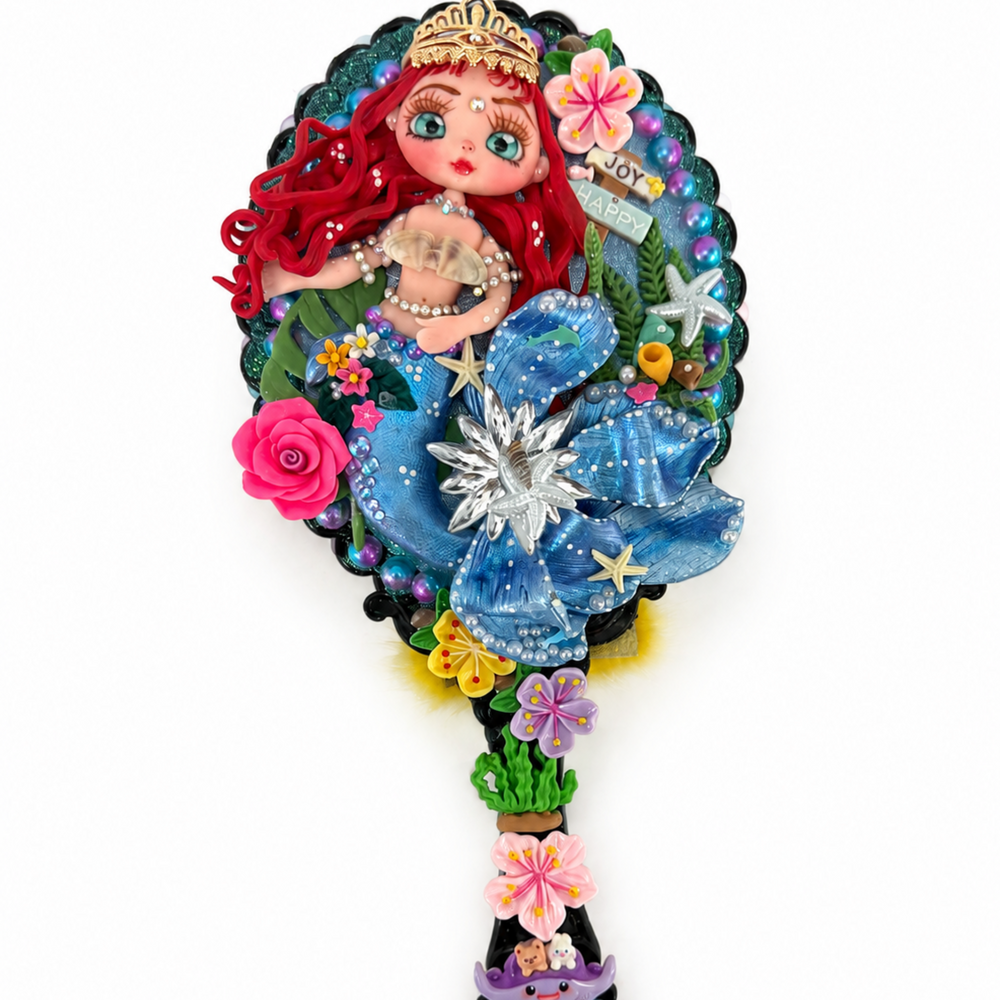 Handmade mermaid vanity mirror with flexible porcelain figure, pearls, shells, starfish and floral accents