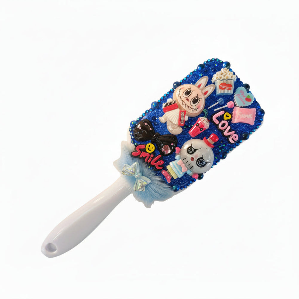Handmade monster decorated hair brush with sparkling royal blue crystals and character charms on white handle