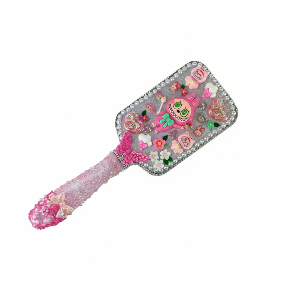 Handmade white monster decorated hair brush with a sparkling silver glitter background and cute charms
