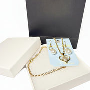 Romantic jewelry gift set with heart necklace, pearl earrings, white jewelry box, and black gift bag.