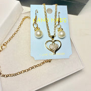 Close-up of handmade pink faux pearl earrings with gold-tone accents.