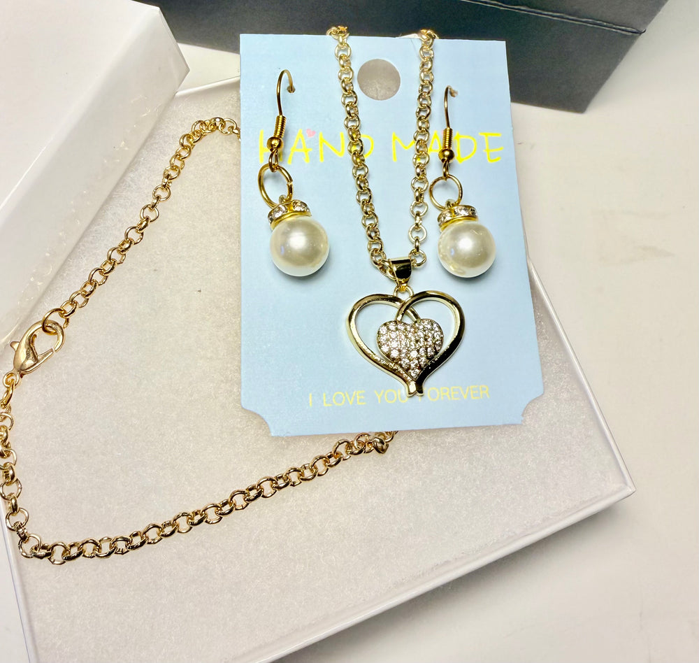 Close-up of handmade pink faux pearl earrings with gold-tone accents.