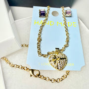 Gold-tone crystal heart necklace and earring gift set in premium packaging with gift bag close up
