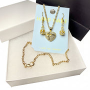 Close-up of a sparkling rhinestone heart pendant on gold-tone chain, handcrafted jewelry for romantic gifts.