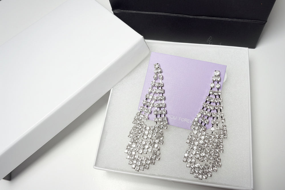 Elegant jewelry gift set presentation with sparkly rhinestone earrings and high-quality gift packaging