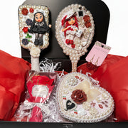 Handmade Decoden vanity set featuring a decorated mirror, hair brush, jewelry box with cold porcelain doll, red soap roses, and artisan earrings.