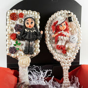 Handmade Decoden vanity set featuring a decorated mirror, hair brush, jewelry box with cold porcelain doll, red soap roses, and artisan earrings.