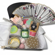 Luxury teal and gold spa gift basket for women featuring a designer hand fan, aromatic candle, bath bombs, and a ceramic bowl set in a premium birthday arrangement.