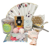 Luxury teal and gold spa gift set for women featuring a designer hand fan, aromatic candle, bath bombs, and a ceramic bowl set in a premium birthday arrangement.