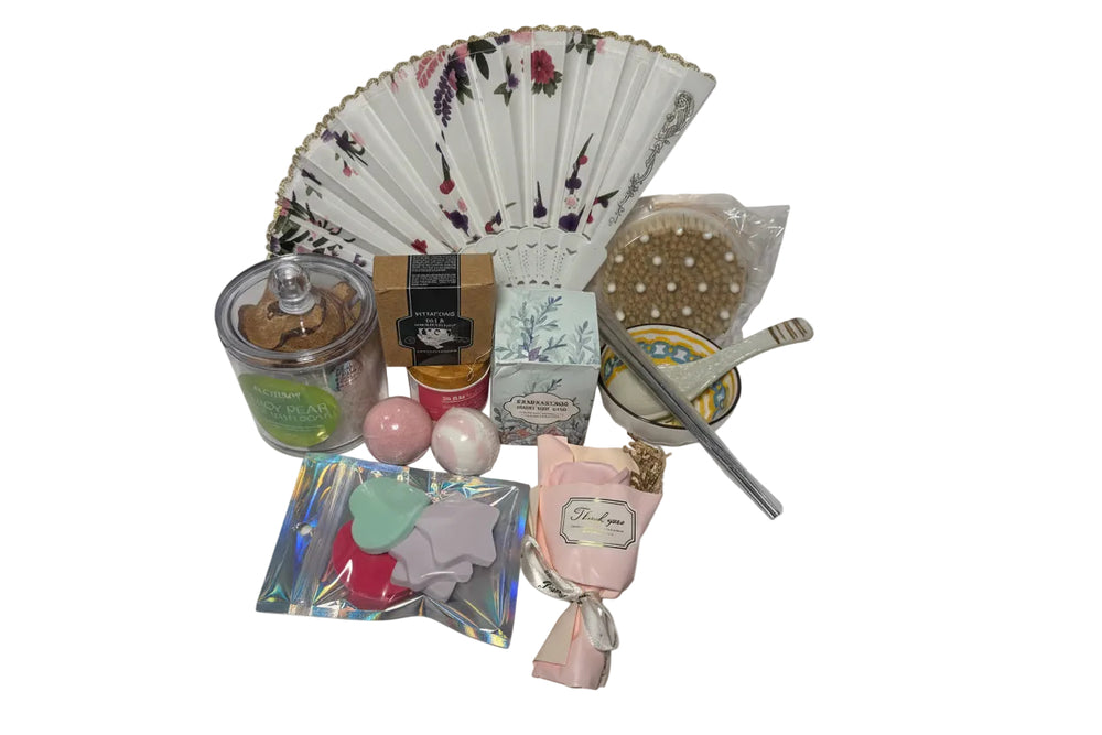 Luxury teal and gold spa gift basket for women featuring a designer hand fan, aromatic candle, bath bombs, and a ceramic bowl set in a premium birthday arrangement.