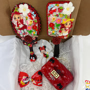 close up of matching red decorated hand mirror and hair brush with handmade strawberry flex porcelain dolls and flowers