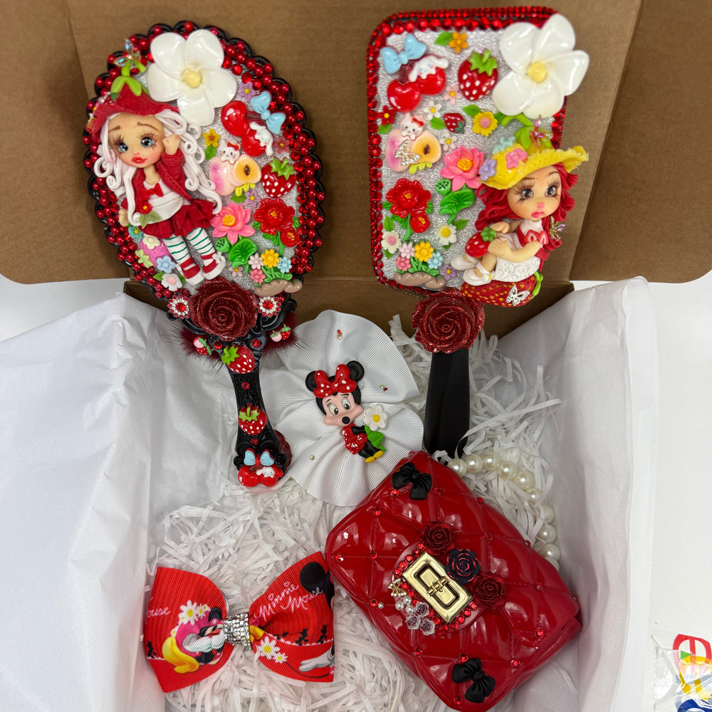 close up of matching red decorated hand mirror and hair brush with handmade strawberry flex porcelain dolls and flowers
