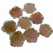 Iridescent rose-shaped objects on a white background