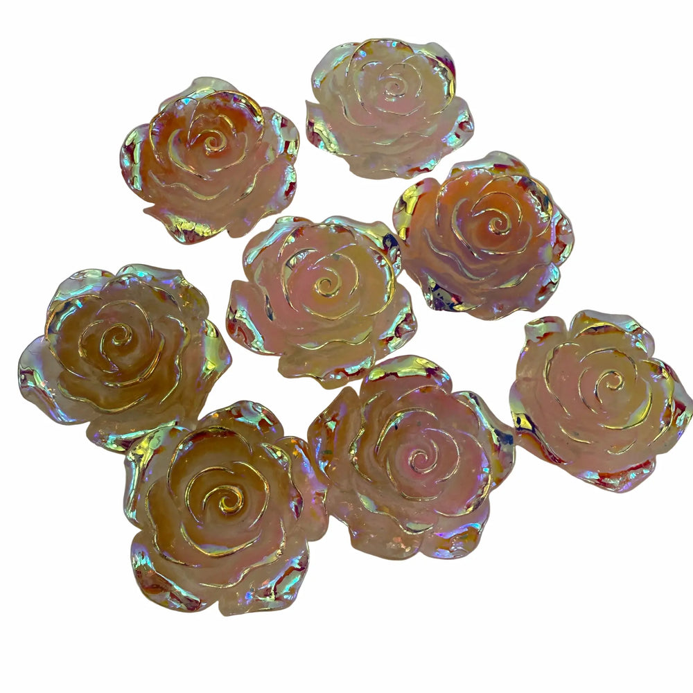 Iridescent rose-shaped objects on a white background