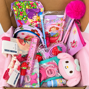 Kawaii pink gift set with strawberry notebook, pens, socks, cosmetic pouch, hair ties, ruler, and assorted accessories in an open box.