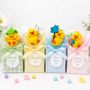 Mini yellow duck figures standing upright together on a white background