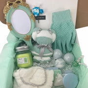 Mint green spa gift box with vintage handheld mirror, candle, bath bombs, teddy bear towel, and jewelry
