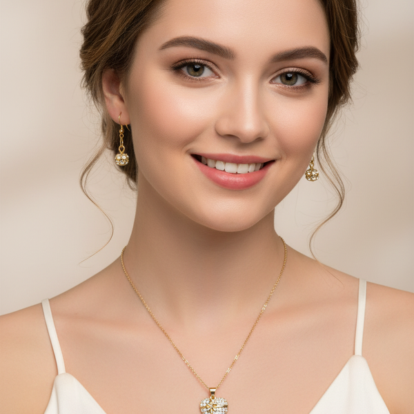 Model wearing a handmade gold tone necklace with a sparkling rhinestone heart pendant and matching earrings.