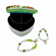 Open enchanted forest heart jewelry box with green beaded bracelets