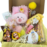 Open kawaii gift box with plush journal, yellow bunny plush, bracelet, mirror, stationery, and handmade accents.