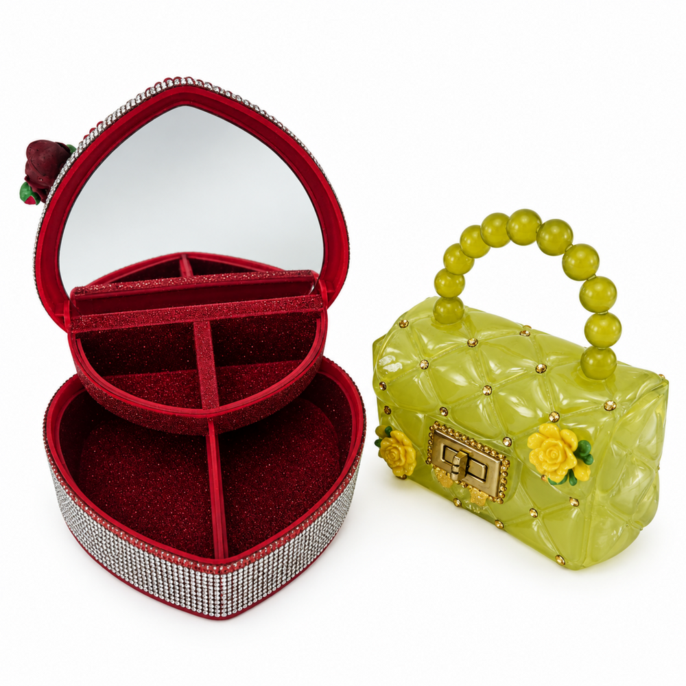 Open red heart jewelry box with mirror and divided storage compartments shown beside a yellow-green decorative mini purse.