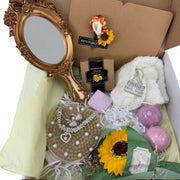 Petal & Glam spa gift set with vintage gold mirror, sunflower hand soap, bath bombs, and rhinestone purse charm