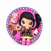 Pink glitter compact decorated with a sculpted girl, purple rhinestones, strawberry milk, cookies, and sweet treats.
