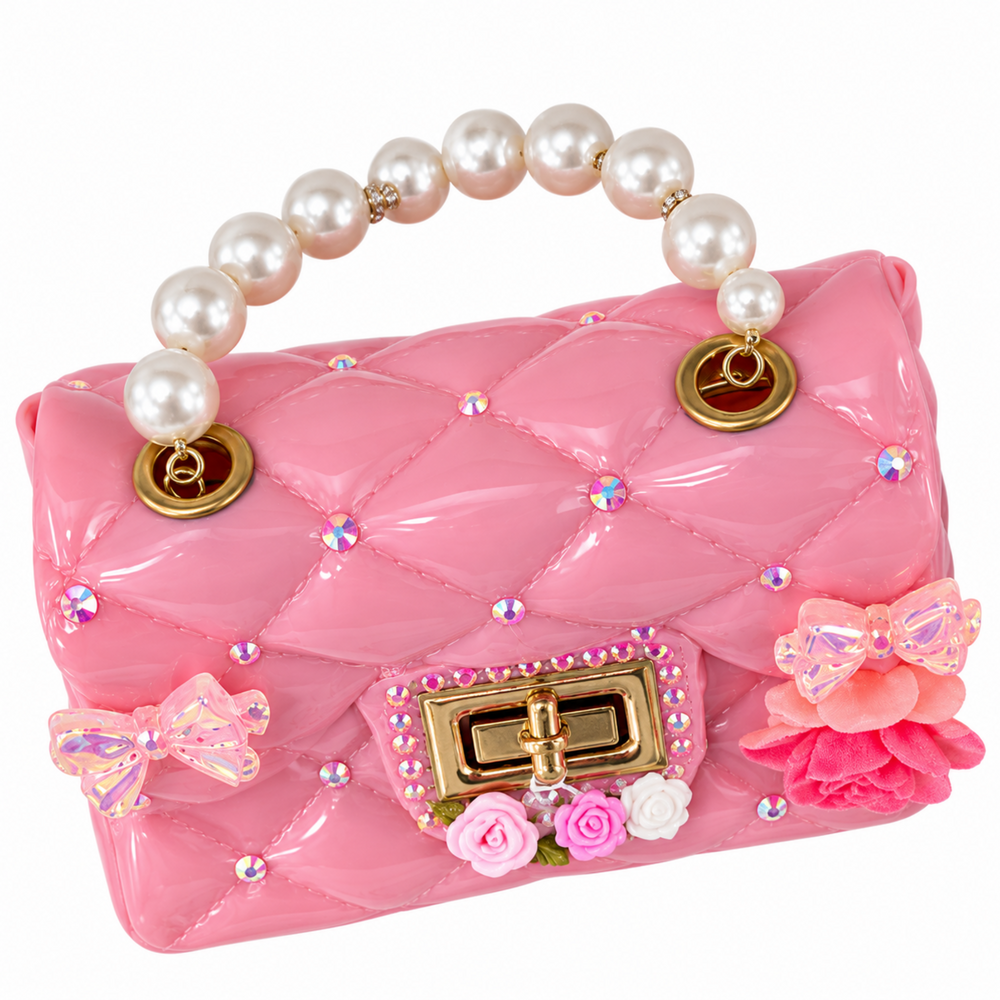 Pink quilted purse with a glossy finish, large pearl handle, gold-tone clasp, delicate bow accents, rhinestones, and small pink floral details on the front.