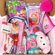 Pink strawberry-themed gift box filled with stationery, socks, pouches, hair accessories, beauty items, and cute plush accessories.