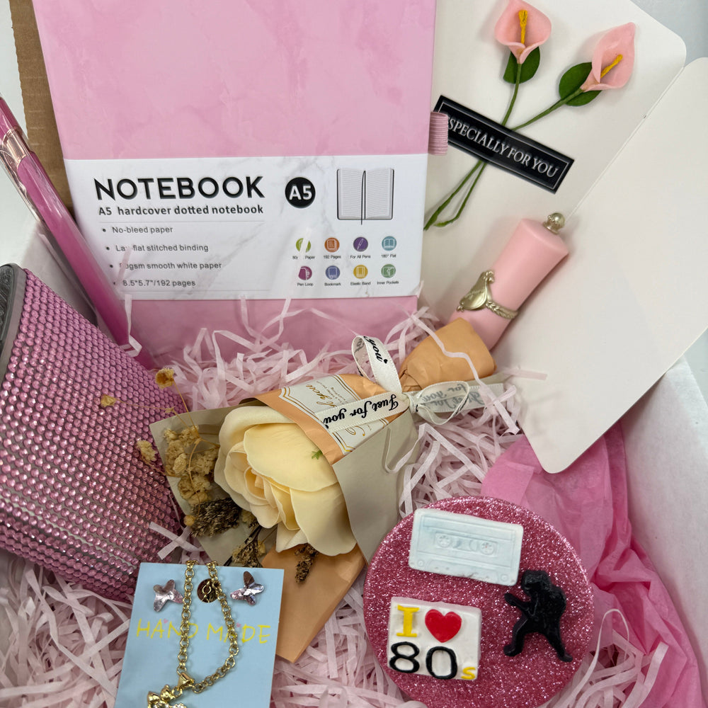 Retro Glam gift set featuring pink A5 notebook, crystal butterfly earrings, heart necklace, flask, and 80s compact mirror