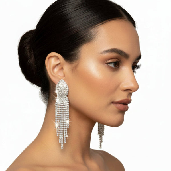 Rhinestone fringe statement earrings with sparkling crystal details displayed in a white jewelry gift box.
