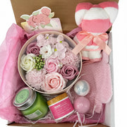 Rose spa gift set with bath bombs, sugar scrub, aromatherapy candle, and teddy bear towel in a premium box