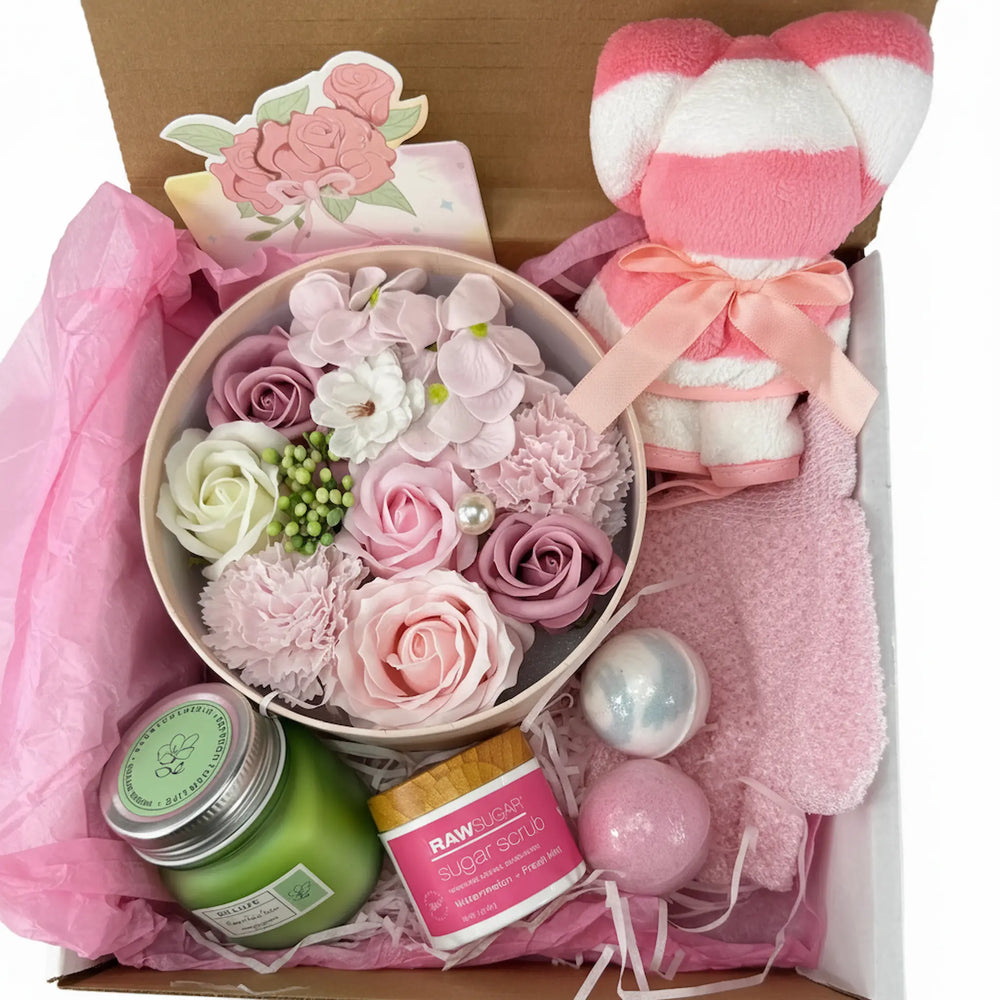 Rose spa gift set with bath bombs, sugar scrub, aromatherapy candle, and teddy bear towel in a premium box