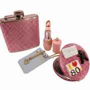 Set of accessories including a steel flask, heart pendant, crystal butterfly earrings, lip gloss, and 80s compact mirror