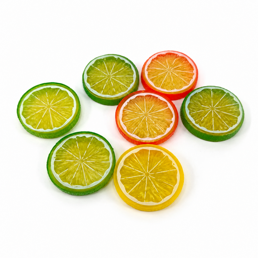 Seven colorful lemon, lime, and orange resin citrus slice flatbacks for DIY crafts