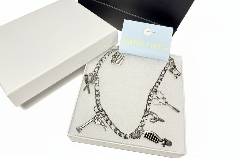Silver charm anklet for hairdressers featuring detailed scissor and comb pendants, 