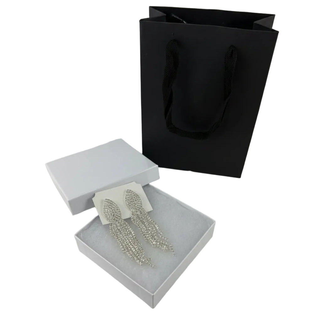 Silver statement earrings featuring cascading rhinestone strands and elegant fringe design for women.
