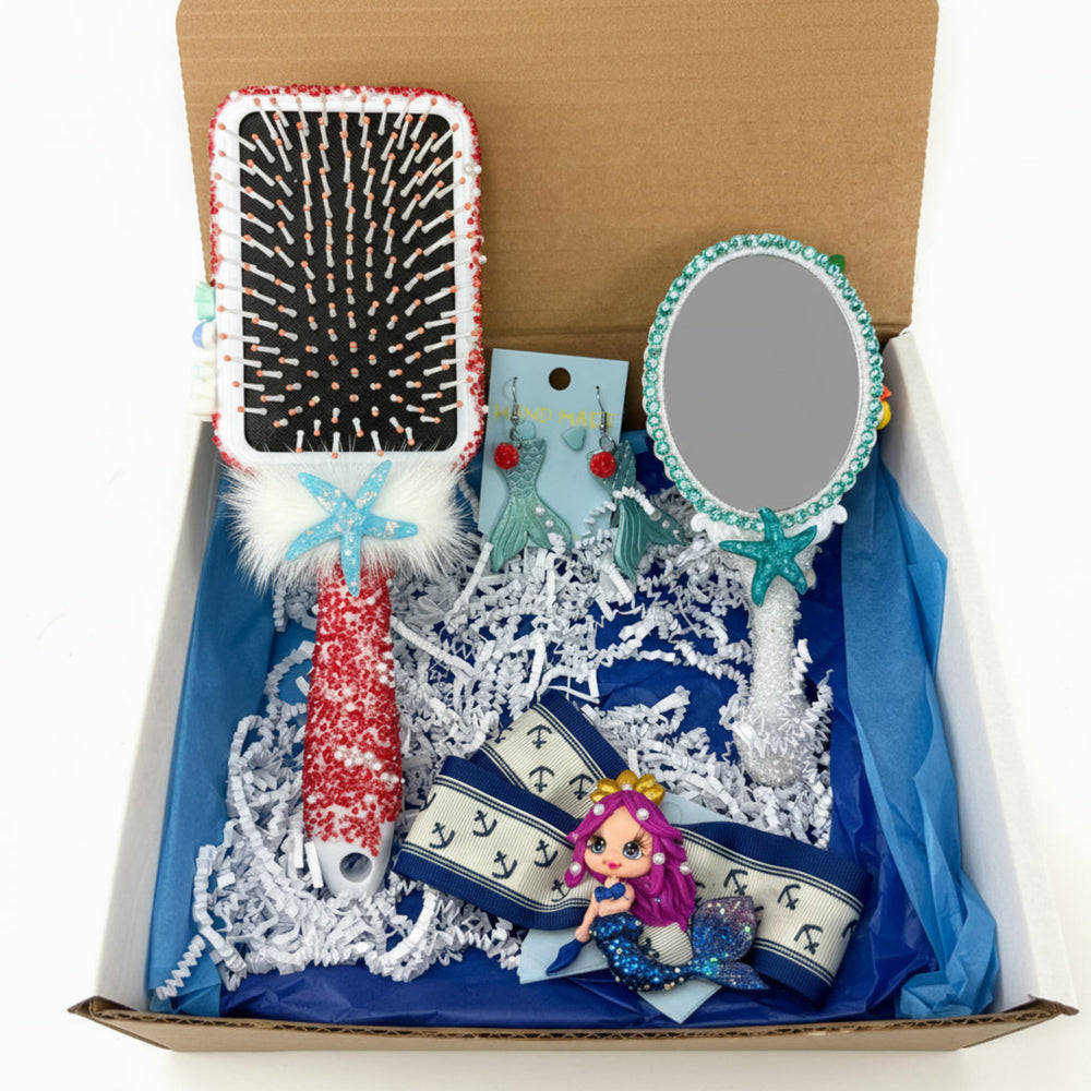 Small decorated mirror with ocean charms and flowers, and mermaid hair bow with clay doll detail