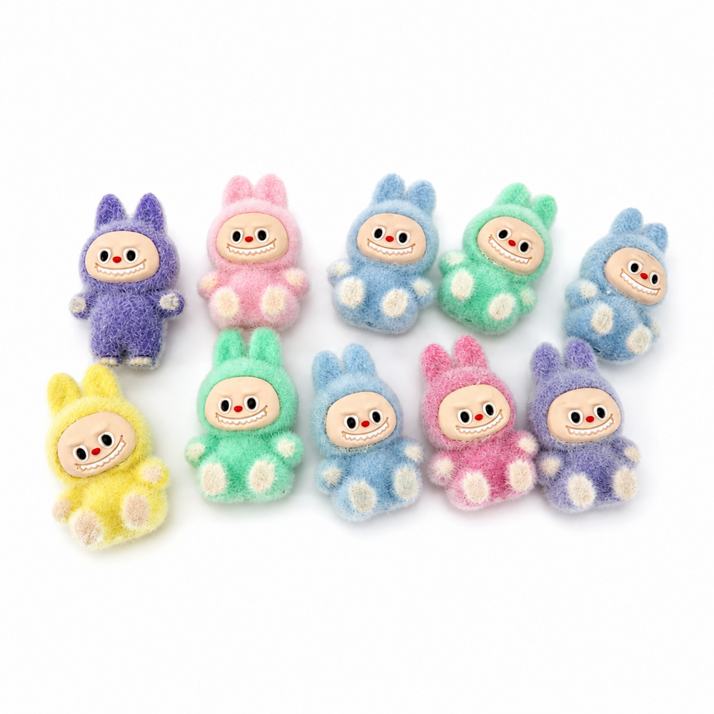 Small fuzzy bunny-style collectible figures displayed on a white background
