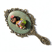 Smooth flat back of a handmade porcelain doll charm, ideal for DIY mirrors, hairbrushes, and custom phone cases