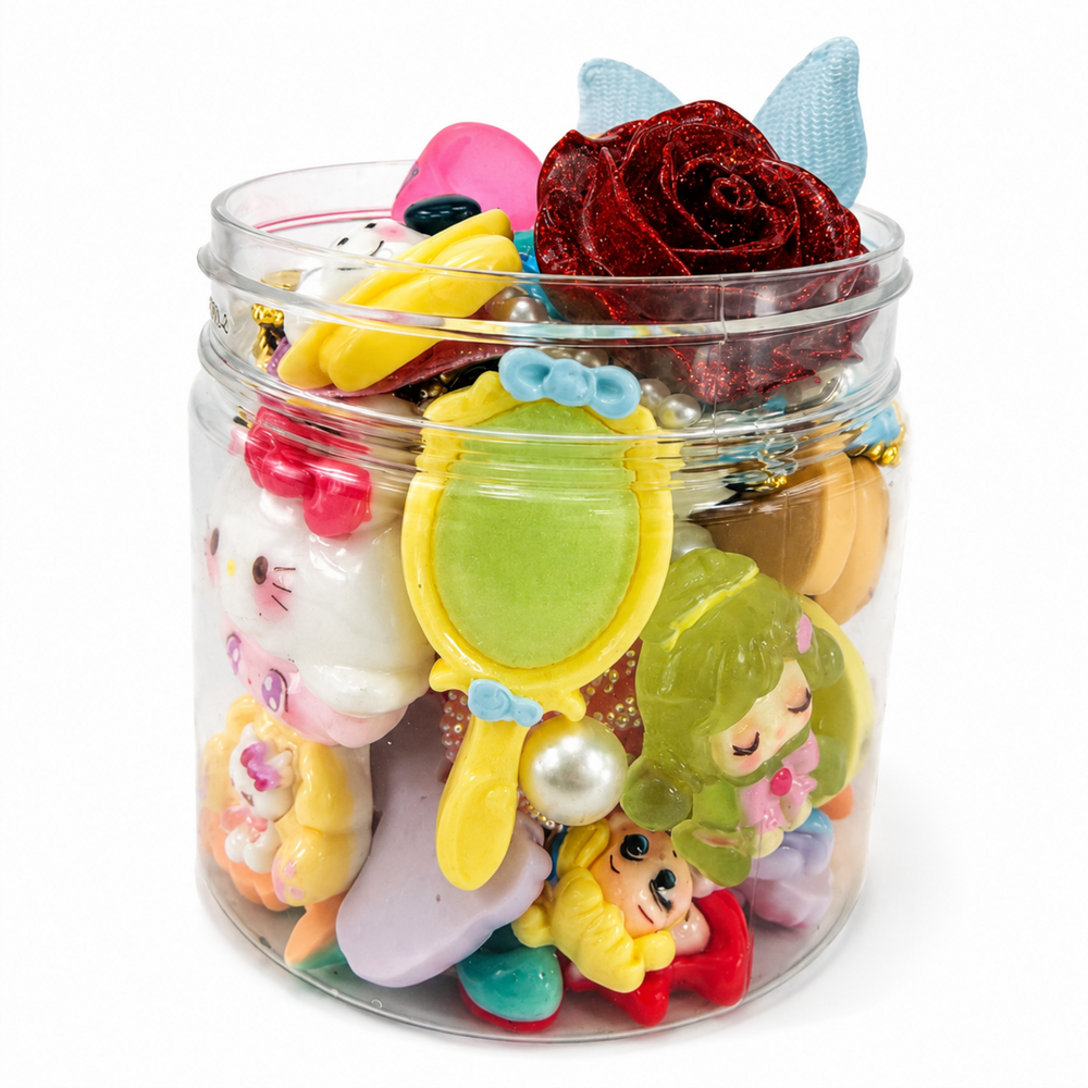 Top view of assorted princess and mermaid charms with bows, roses, pearls and sparkling decorative pieces.
