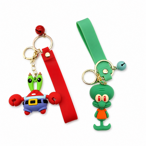 Two cartoon character silicone keychains with red and green wrist straps