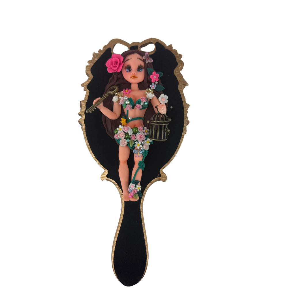 artisan flexible cold porcelain fairy doll flatback centerpiece displayed next to a decorated mirror