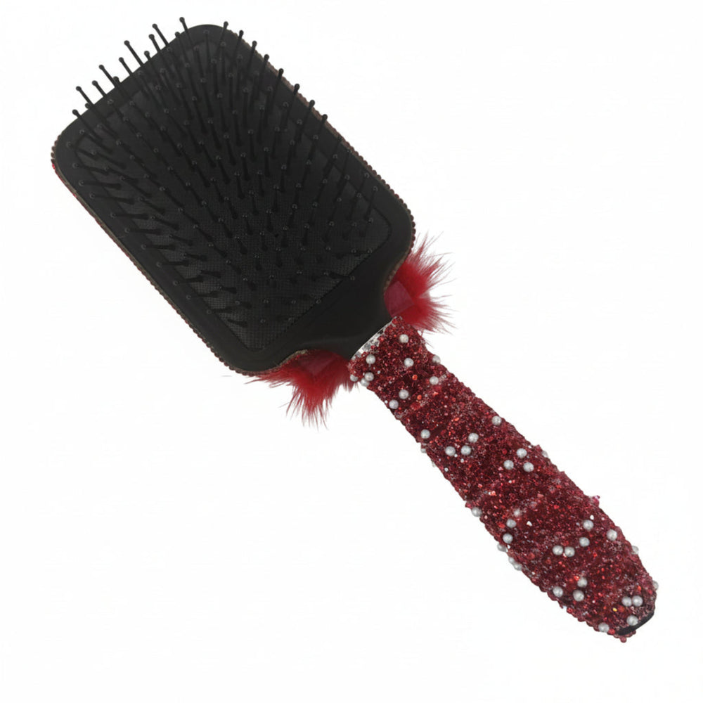 back of black hair brush showing handle with red fur trim and soft bristles for vanity hair styling decor