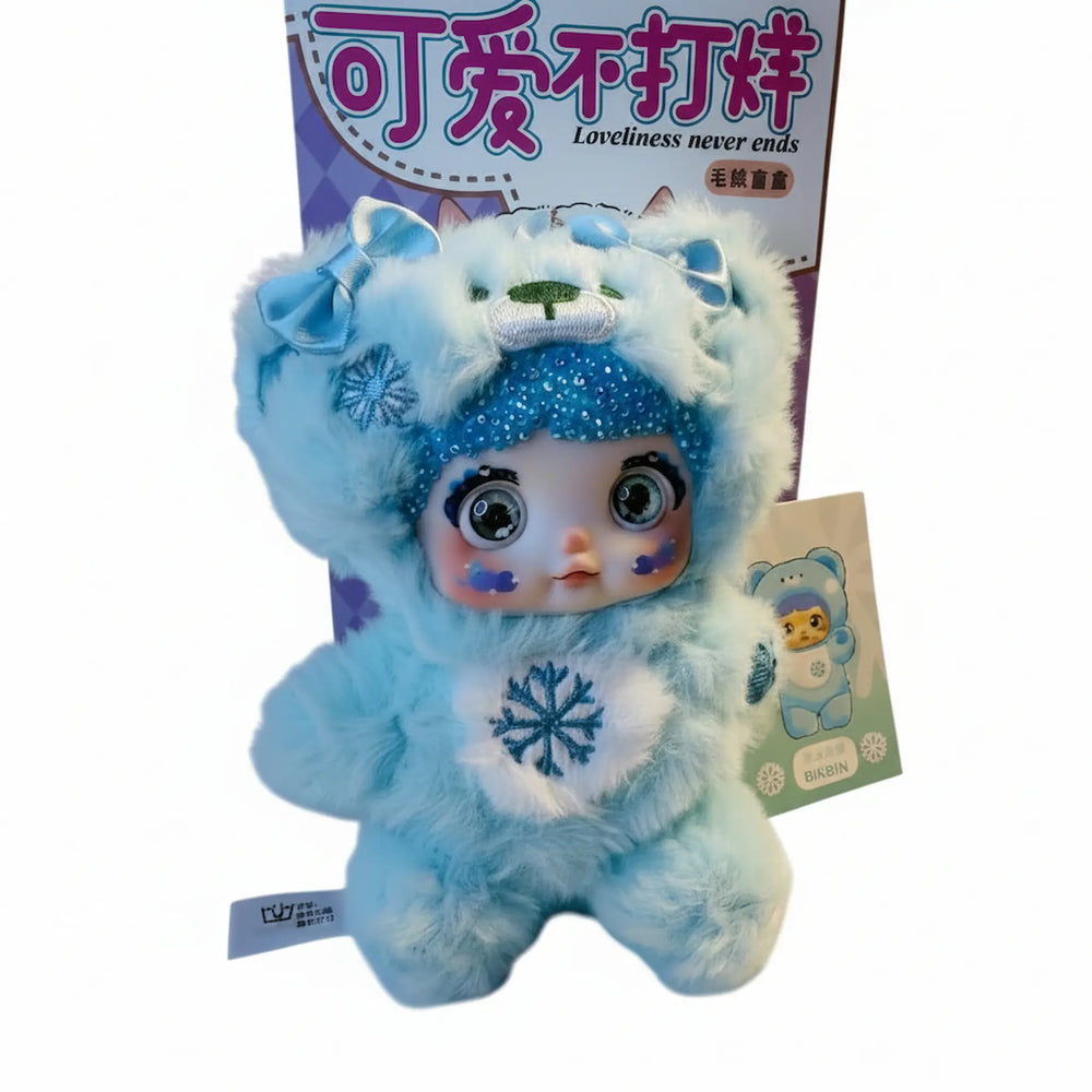 blue nommi kawaii plush pendant with sparkling crystal accents and snowflake design