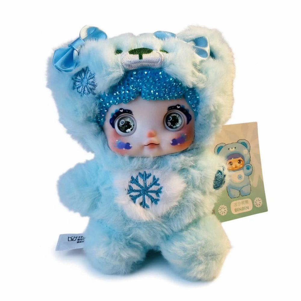 close-up of blue nommi plush showing sparkling crystal bedazzled details and blue fur