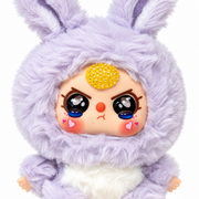 close-up of lilac baby three plush with blue tears, pink heart cheeks and sparkling yellow crystal accent