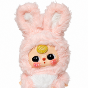 close-up of pink baby three plush with long bunny ears, white cheek details and sparkling yellow crystal forehead accent