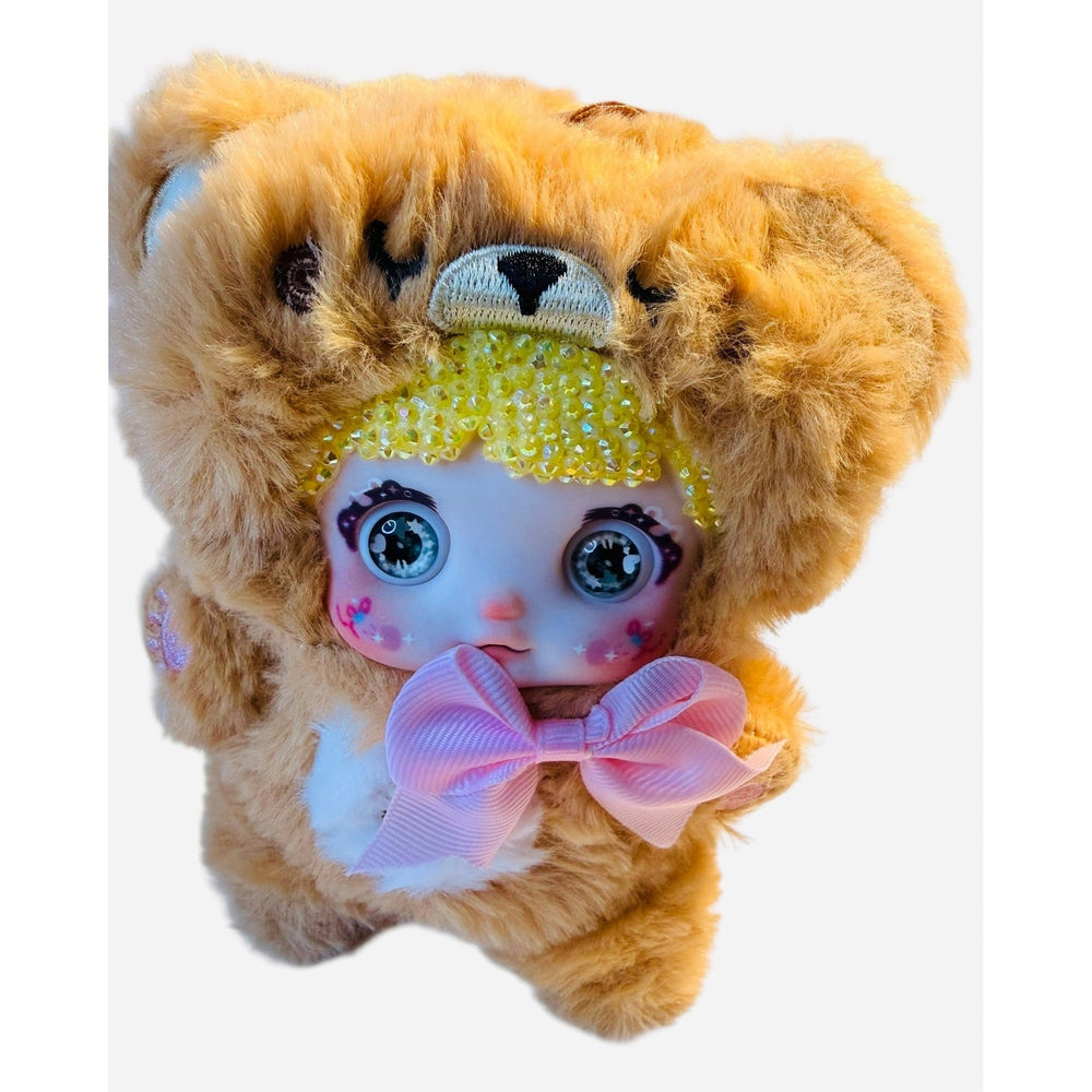close-up of yellow nommi plush showing sparkling crystal bedazzled details and yellow fur